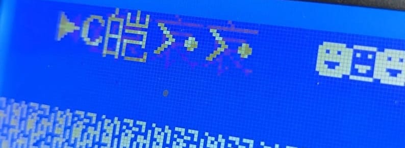 A seriously failed Marlin firmware update showing broken emojis on a blue LCD screen